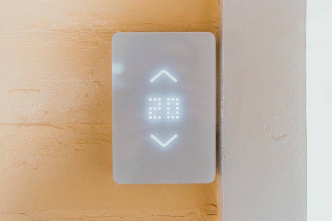 A sleek, modern home with digital data overlays or screens showing property information.