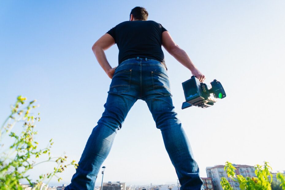 Professional, uniformed roofer carefully inspects the shingles on a sunlit residential roof, ensuring its quality and dura...