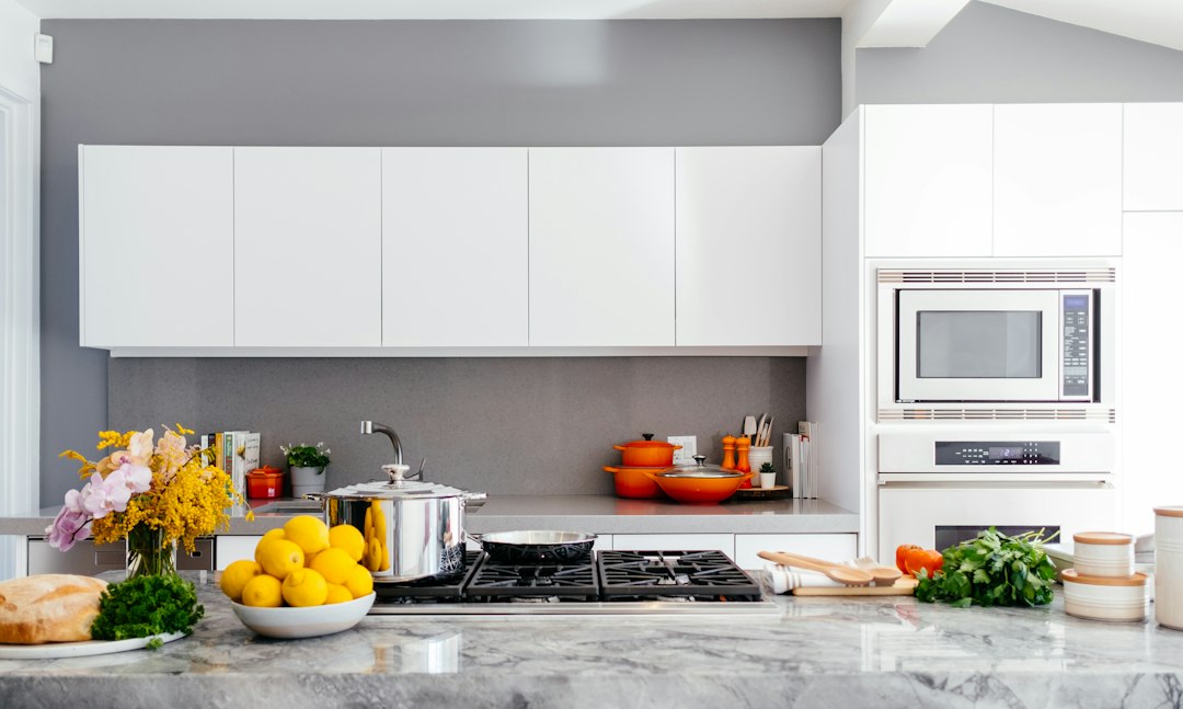 A sparkling clean modern kitchen counter with minimal, tasteful decor, demonstrating the impact of decluttering for home staging.